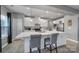 Bright kitchen with white cabinets, stainless appliances, a center island, and wood-look flooring at 1018 Hinson Forest Rd, Monroe, NC 28110