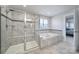 Luxurious main bathroom with tiled walk-in shower and soaking tub with window at 1018 Hinson Forest Rd, Monroe, NC 28110