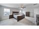 Spacious main bedroom with two windows providing natural light, and a ceiling fan for added comfort at 1018 Hinson Forest Rd, Monroe, NC 28110