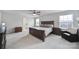 Inviting main bedroom with a large bed, sitting area, natural light, and neutral carpet at 1018 Hinson Forest Rd, Monroe, NC 28110