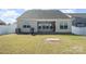 Large backyard with a covered patio, grill, and white privacy fence, perfect for outdoor gatherings at 108 Toxaway St, Mooresville, NC 28115