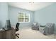 Well-lit bedroom with a cozy seating area, neutral decor, and ample natural light at 108 Toxaway St, Mooresville, NC 28115