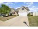 Charming home with a two-car garage, well-manicured lawn, and a welcoming driveway, great curb appeal at 108 Toxaway St, Mooresville, NC 28115