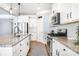 Modern kitchen featuring granite countertops, stainless steel appliances, and white cabinetry at 108 Toxaway St, Mooresville, NC 28115