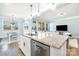 Modern open-concept kitchen features granite countertops, stainless steel appliances, and seamless living room connection at 108 Toxaway St, Mooresville, NC 28115