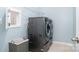 Well-lit laundry room featuring modern washer and dryer with front loading and storage basket at 108 Toxaway St, Mooresville, NC 28115