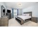 Comfortable bedroom with neutral tones, large windows, and stylish furniture at 108 Toxaway St, Mooresville, NC 28115
