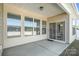 Covered back patio with plenty of natural light and sliding glass doors to the house at 108 Toxaway St, Mooresville, NC 28115