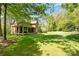 Spacious backyard with a covered porch, providing a serene outdoor living space and lush lawn at 1116 Landons Ct, China Grove, NC 28023