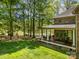 Back exterior of the house featuring a large backyard and covered porch with a table and chairs at 1116 Landons Ct, China Grove, NC 28023