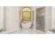 The bathroom has a modern tub under a window, marble floors and walk-in shower at 1116 Landons Ct, China Grove, NC 28023