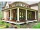 Covered porch with outdoor dining set, perfect for relaxing and enjoying the beautiful surroundings at 1116 Landons Ct, China Grove, NC 28023
