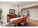 Dining room features hardwood floors, chandelier, and a view into the kitchen at 1116 Landons Ct, China Grove, NC 28023