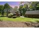 Exterior view showcasing the house, expansive lawn, and additional garage with ample parking at 1116 Landons Ct, China Grove, NC 28023
