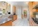The kitchen has tile floors, stainless appliances, wood cabinets, granite countertops and a pass-through to the living room at 1116 Landons Ct, China Grove, NC 28023