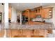 The kitchen has stainless appliances, wood cabinets and granite countertops and a bar height counter with seating at 1116 Landons Ct, China Grove, NC 28023