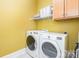 The laundry room includes a washer, dryer, cabinets and shelving for storage at 1116 Landons Ct, China Grove, NC 28023