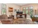 Bright home office with large windows, hardwood floors, and a comfortable chair at 1116 Landons Ct, China Grove, NC 28023