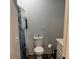 Clean bathroom featuring a white toilet, towel holder, and shower with blue curtain at 113 Hideaway Trl, Mount Gilead, NC 27306