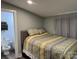 Bedroom with a decorative bedspread and a connecting bathroom at 113 Hideaway Trl, Mount Gilead, NC 27306