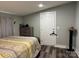 Bedroom with a bed, wood-look floors, and gray walls at 113 Hideaway Trl, Mount Gilead, NC 27306