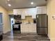 The kitchen features new stainless steel appliances, white cabinets, and modern countertops at 113 Hideaway Trl, Mount Gilead, NC 27306