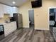 The kitchen features new stainless steel appliances, white cabinets, and modern countertops at 113 Hideaway Trl, Mount Gilead, NC 27306