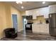 The kitchen features new stainless steel appliances, white cabinets, and modern countertops at 113 Hideaway Trl, Mount Gilead, NC 27306