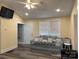 Cozy living room features natural light from windows, wood floors and comfortable seating at 113 Hideaway Trl, Mount Gilead, NC 27306