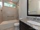 This bathroom features a vanity with granite countertop, a shower-tub combo and a window at 11447 Egrets Point Dr, Charlotte, NC 28278