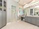 Open view of the bathroom featuring a glass shower, gray cabinets, dual sinks, and a vanity area at 11447 Egrets Point Dr, Charlotte, NC 28278