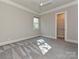 This bedroom features neutral walls, carpet, ceiling fan, window, and a spacious closet at 11447 Egrets Point Dr, Charlotte, NC 28278