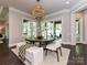 Dining room with round table, stylish light fixture, and sliding doors to the outdoor patio at 11447 Egrets Point Dr, Charlotte, NC 28278