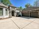 Elegant home featuring a stone facade and a spacious driveway leading to a multi-car garage at 11447 Egrets Point Dr, Charlotte, NC 28278