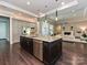 Kitchen island with granite countertop, stainless dishwasher, and open floor plan at 11447 Egrets Point Dr, Charlotte, NC 28278