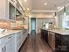 Spacious kitchen features gray cabinets, stainless appliances, granite countertops, and an island with seating at 11447 Egrets Point Dr, Charlotte, NC 28278