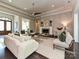 Comfortable living room with a fireplace, refined decor, and seamless access to the dining area at 11447 Egrets Point Dr, Charlotte, NC 28278