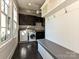 This mudroom features built-in cabinets, bench, coat hooks, a sink and a washer and dryer at 11447 Egrets Point Dr, Charlotte, NC 28278