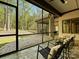 This screened porch features natural views, slate tile floors and an outdoor ceiling fan at 11447 Egrets Point Dr, Charlotte, NC 28278