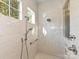 Step into the luxurious, all-tile shower with glass surround and rainfall shower head at 11447 Egrets Point Dr, Charlotte, NC 28278