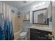 Bathroom with a shower-tub combo, vanity with marble countertop, and convenient storage cabinet at 117 Heath Ln, Mooresville, NC 28117