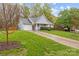 Exterior home elevation showcasing a landscaped front yard and asphalt driveway at 117 Heath Ln, Mooresville, NC 28117