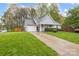 Charming single-Gathering home with a well-manicured lawn and an attached one car garage at 117 Heath Ln, Mooresville, NC 28117