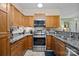 Beautiful kitchen with stainless steel appliances, granite countertops, and wooden cabinetry at 117 Heath Ln, Mooresville, NC 28117