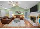Comfortable living room featuring a fireplace, hardwood floors, and a leather sofa set at 117 Heath Ln, Mooresville, NC 28117