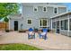 Backyard patio area featuring two blue chairs and a table, perfect for outdoor relaxation and entertaining at 11700 Fernhurst Ln, Charlotte, NC 28277