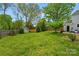 Spacious backyard with green grass, a storage shed, and a wood fence for privacy at 11700 Fernhurst Ln, Charlotte, NC 28277