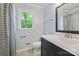 Updated bathroom featuring a modern vanity, toilet, tile flooring and shower with curtain at 11700 Fernhurst Ln, Charlotte, NC 28277