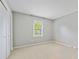 Bright bedroom featuring neutral walls, carpet, closet, and natural light from a window with blinds at 11700 Fernhurst Ln, Charlotte, NC 28277