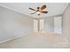 Spacious bedroom with ensuite bathroom and closet doors and a ceiling fan at 11700 Fernhurst Ln, Charlotte, NC 28277
